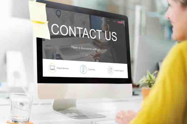 Woman viewing a 'Contact Us' page that builds website trust.